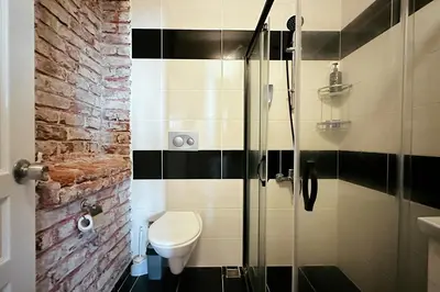 a bathroom with a toilet and a glass shower at The Haliç Bosphorus Hotel in Istanbul