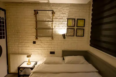 a bedroom with a bed and a white brick wall at Ava Istanbul City Center Hotel in Istanbul