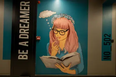 a poster of a girl reading a book at Ava Istanbul City Center Hotel in Istanbul