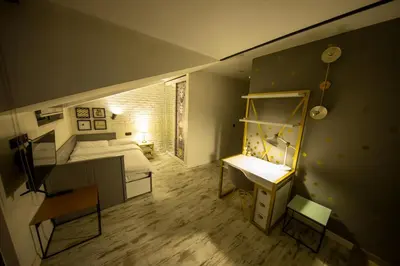 a small room with a bed and a desk and a bed and a room with at Ava Istanbul City Center Hotel in Istanbul