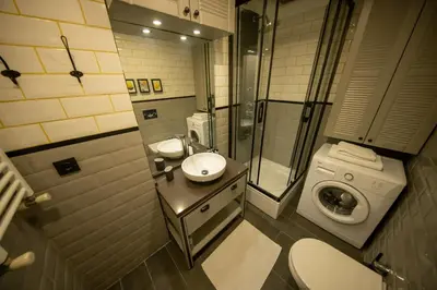 a bathroom with a sink and a washing machine at Ava Istanbul City Center Hotel in Istanbul