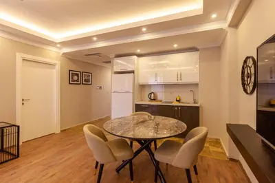 a kitchen and dining room with a table and chairs at Lilium Luxury Suites in Istanbul
