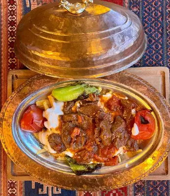a bowl of food with meat and vegetables on a table at Ottoman Luxury Hotel in Istanbul