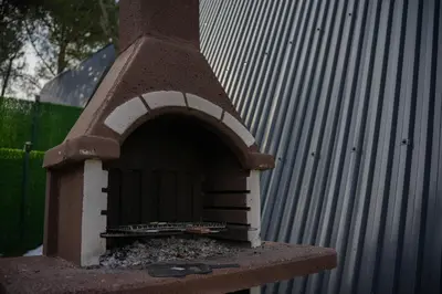 a brick oven sitting next to a building at Bungalov Maşukiye Villa in Kartepe