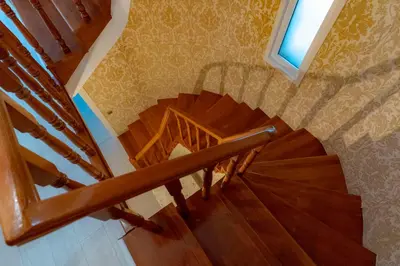 a wooden spiral staircase in a home with a window at Bungalov Maşukiye Villa in Kartepe