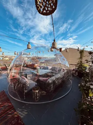 a glass dome with couches and chairs on a patio at Waterfront Apartment by the Tram - Terrace with Dome & Golden Horn View in Fatih in Istanbul