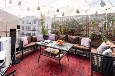 a patio with a couch and a table on a balcony at Waterfront Apartment by the Tram - Terrace with Dome & Golden Horn View in Fatih in Istanbul