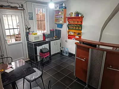 a small kitchen with a table and a counter top at Taksim History Wooden Hostel in Istanbul