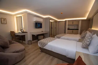 a hotel room with two beds and a couch at Vera Life Hotel in Istanbul
