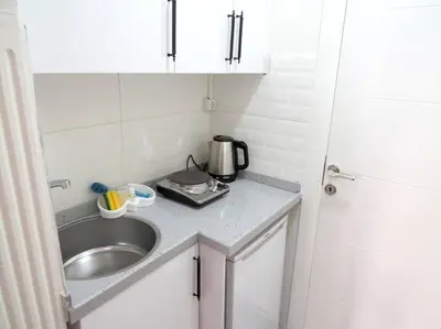 a small kitchen with a sink and a microwave at Istanberry - Royal Apartments in Istanbul