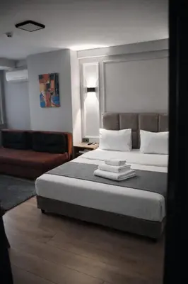 a bedroom with a bed with towels on it at Olen Uskudar Hotel in Istanbul