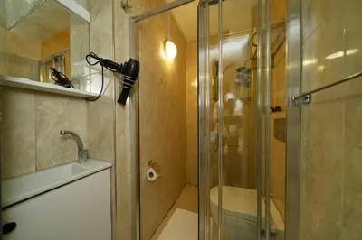 a bathroom with a shower and a glass shower door at Elite Marmara Boutique Hotel Sultanahmet in Istanbul