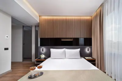 a bedroom with a large bed with two wine glasses at Nish Palace Beşiktaş in Istanbul