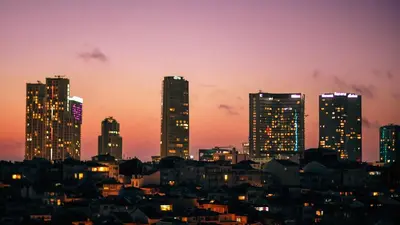 a city skyline with tall buildings at night at sevim suites With a sea view in nişantaşı in Istanbul