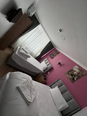 an overhead view of a bedroom with a bed and pink floor at MİRHAN HOTEL in Istanbul