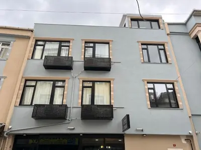 a gray building with windows and balconies on it at MİRHAN HOTEL in Istanbul