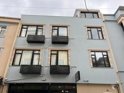 a gray building with windows and balconies on it at MİRHAN HOTEL in Istanbul