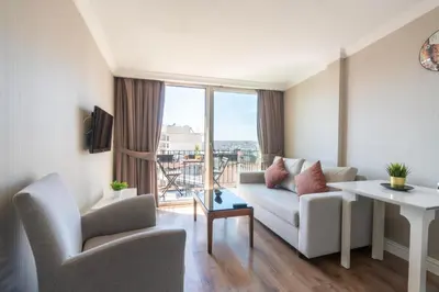 a living room with a couch and a table and chairs at 6 Apartment Galata in Istanbul