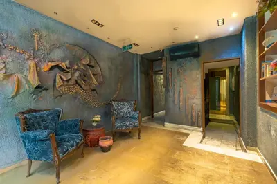 a room with two chairs and a wall with a painting at 6 Apartment Galata in Istanbul