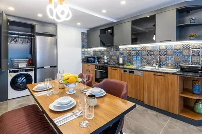 a kitchen with a wooden table and chairs at Baymari Suites Design Florya in Istanbul