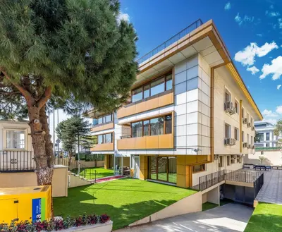 an apartment building with a tree in front of it at Baymari Suites Design Florya in Istanbul