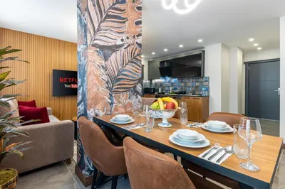a dining room with a table with a bowl of fruit at Baymari Suites Design Florya in Istanbul