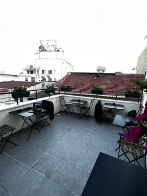 a balcony with tables and chairs on a building at Mr Miller Suite in Istanbul