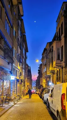 a city street at night with cars parked at Tam Merkezde Yepyeni Bir Daire in Istanbul