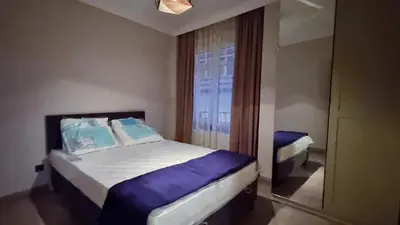 a small bedroom with two beds and a window at Tam Merkezde Yepyeni Bir Daire in Istanbul