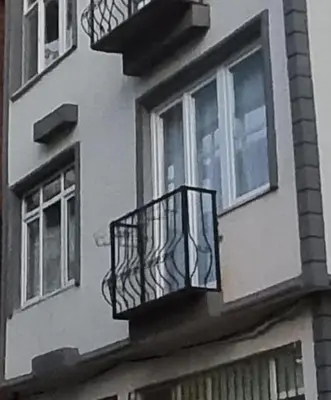 a building with a balcony on the side of it at Tam Merkezde Yepyeni Bir Daire in Istanbul