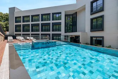 a swimming pool in front of a building at INVENTIST Hotel Sports Academy Istanbul in Istanbul