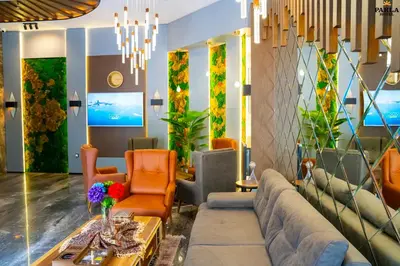 a living room with a couch and chairs at Parla Suite Hotel in Esenyurt