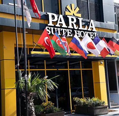 a hotel with flags on the front of it at Parla Suite Hotel in Esenyurt