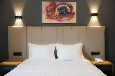a bedroom with a bed with two white pillows at HOME PLUS Hotel in Istanbul