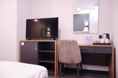 a bedroom with a desk with a television and a chair at HOME PLUS Hotel in Istanbul