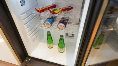 an open refrigerator filled with drinks and snacks at Bellezza Hotel in Istanbul