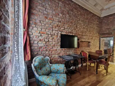 a room with a brick wall with a table and chairs at Casa 1899 in Istanbul