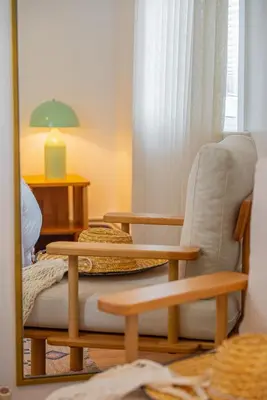 a mirror in a room with a chair and a couch at Terra House Sapanca in Sapanca