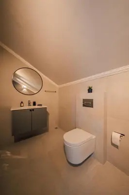 a bathroom with a toilet and a sink and a mirror at Terra House Sapanca in Sapanca