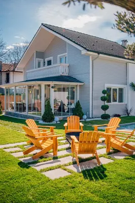 a group of chairs in front of a house at Terra House Sapanca in Sapanca