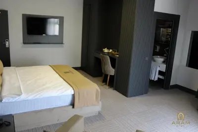 a bedroom with a bed and a table with a sink at Aram Otel Business & Luxury in Istanbul