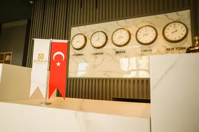 a table with clocks on a wall with a presentation at Aram Otel Business & Luxury in Istanbul