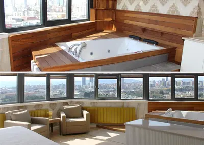 a bath tub in a room with windows at Aram Otel Business & Luxury in Istanbul