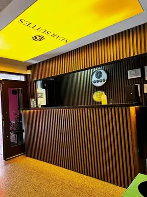 a restaurant with a wooden wall with a yellow ceiling at NEAR SUITES in Istanbul