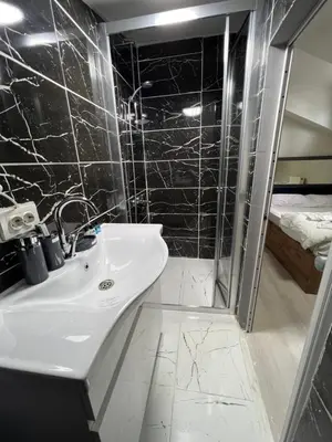 a bathroom with a sink and a shower at NEAR SUITES in Istanbul