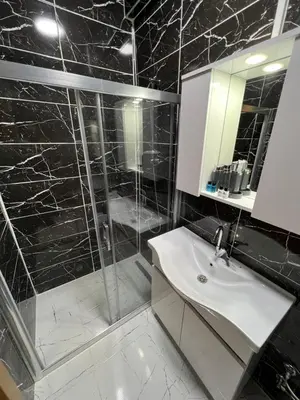 a bathroom with a shower and a sink and a mirror at NEAR SUITES in Istanbul