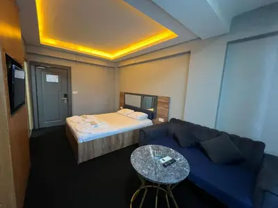 a room with a couch and a bed and a table at NEAR SUITES in Istanbul