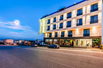 a building with a car parked in front of it at Heaven Premium Hotel Restaurant & Airport Shuttle in Arnavutköy
