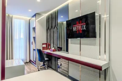 a bedroom with a dressing table and a mirror at Heaven Premium Hotel Restaurant & Airport Shuttle in Arnavutköy