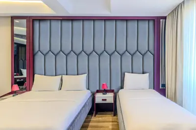 two beds sitting next to each other in a room at Heaven Premium Hotel Restaurant & Airport Shuttle in Arnavutköy